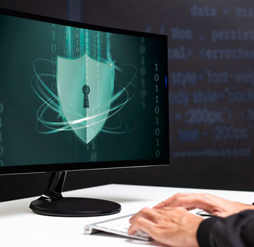 Typing on a keyboard with a security logo on screen